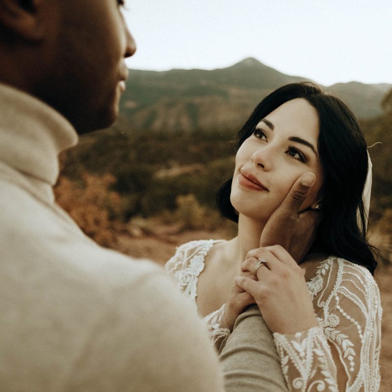 a bride looking at her husband in the mountains of colorado springs